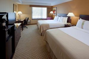 A bed or beds in a room at Armoni Inn & Suites