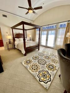 a bedroom with a canopy bed and a rug at Inn on Main Hotel in Manasquan