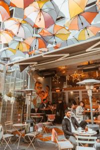 a group of people sitting at tables under umbrellas at PANDAN KARAKOY SUİT in Istanbul