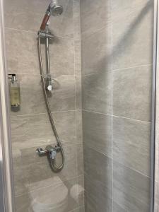 a shower with a shower head in a bathroom at The Promenade Guest House in Bridlington