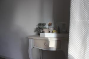 a white table in a corner of a room at LES CHAMBRES DU HOURON in Moliets-et-Maa