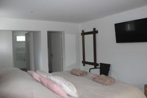 a bedroom with a bed with two pillows on it at LES CHAMBRES DU HOURON in Moliets-et-Maa