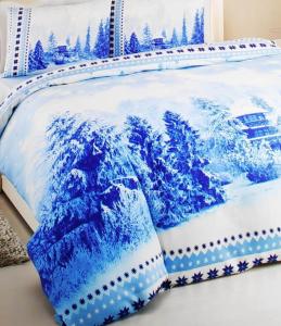 a blue and white bedspread with a picture of a wave at Uptown holiday app daily rental contactless Check In & Check Out in Famagusta