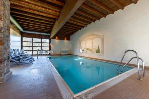 a swimming pool in a house with a ceiling at Jagdschloss Hotel Niederwald in Rüdesheim am Rhein