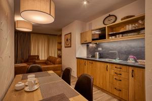 a kitchen and a dining room with a table and a counter at Apartmán Polana in Belá