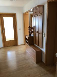 a bathroom with a dresser and a large mirror at 2 Zimmer Wohnung mit Balkon - Nähe Messe in Haar