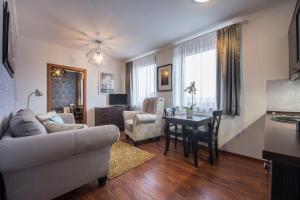 a living room with a couch and a table at G88 RESIDENCE in Veľká Lomnica