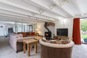 a living room with two couches and a fireplace at The Old Mill in Paignton