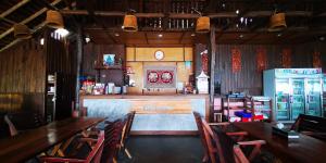 a restaurant with wooden tables and chairs and a bar at Phi Phi Relax Beach Resort in Phi Phi Islands