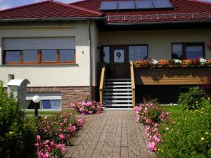 a house with a brick walkway leading to the front door at Cosy apartment in Neustra burg in Balesfeld