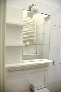 a bathroom with a mirror and a sink at Design Apartments 1 in Dortmund