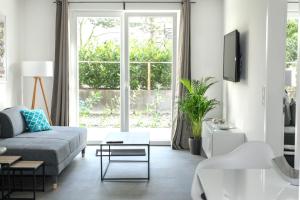 a living room with a couch and a large window at Voss-Haus in Eutin