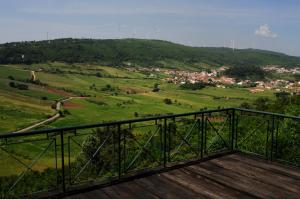 a balcony with a view of a green field at 1/4 na Serra in Rio Maior