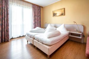 Łóżko lub łóżka w pokoju w obiekcie Erlenhof B&B