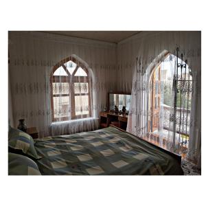 Ένα ή περισσότερα κρεβάτια σε δωμάτιο στο Rahmat guesthouse