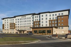 a large white building with a street in front of it at Staybridge Suites - Overland Park - Kansas City S, an IHG Hotel in Overland Park