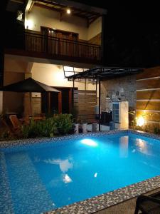 a large blue swimming pool in front of a building at Indah Nusantara in Banyuwangi