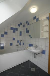 a bathroom with a sink and a bath tub at Chalet Alpina in Bovec