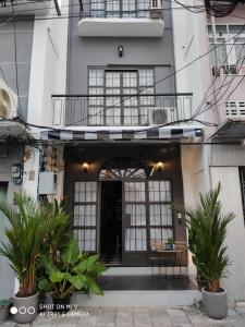 a building with a black door and a balcony at 87 Oldtown at River Pier in Bangkok
