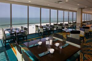 a restaurant with tables and chairs and a view of the beach at Cirque St Armands Beachside in Sarasota