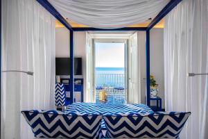 a bedroom with a bed with a view of the ocean at Imperati Suites by Alcione Residence in Positano