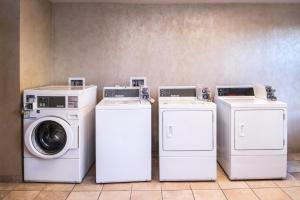 three washing machines and a washer and dryer in a room at Holiday Inn Ontario Airport - California, an IHG Hotel in Ontario