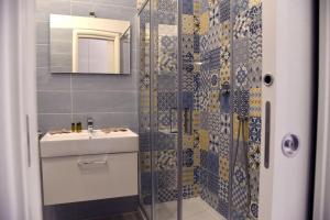 a bathroom with a shower with a sink and a mirror at Casa Sammarco in Naples +25 photos