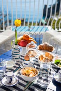 a table topped with plates of food on a table at Imperati Suites by Alcione Residence in Positano