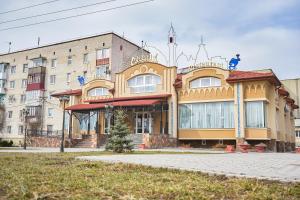 a building on a street in front of a building at Східний in Brzezhany