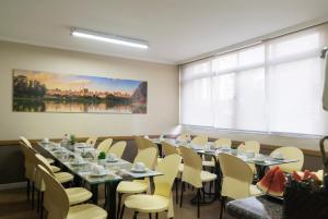 a room with tables and chairs and a large window at Paulista Garden Hotel in São Paulo