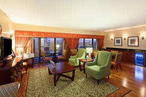 a living room with a couch and chairs and a television at Holiday Inn Sacramento Downtown-Arena, an IHG Hotel in Sacramento