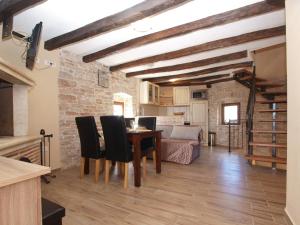 a kitchen and dining room with a table and chairs at House Jasici 2014 in Žminj