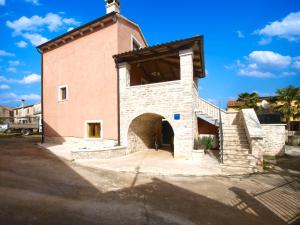 a large brick building with a tower with a doorway at House Jasici 2014 in Žminj