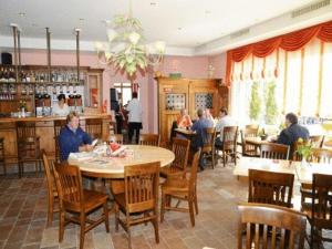 a group of people sitting at a table in a restaurant at Parkhotel Wangs in Wangs