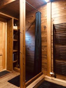 a sauna with a shower in a wooden cabin at Citi Krasti Eco Spa Residence in Kārļzemnieki +288 photos
