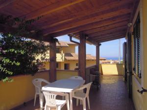 a patio with a table and chairs on a building at Attico La Murighessa in Castelsardo