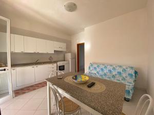 a kitchen with a table and chairs in a room at Casa Vacanze Angelo in Palinuro