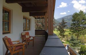 a porch with chairs and a view of a mountain at Zillertal Apartments in Hippach