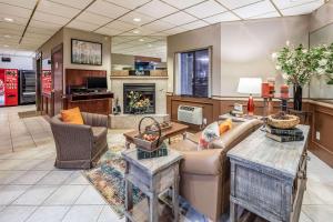 a living room with a couch and a fireplace at Quality Inn Keystone near Mount Rushmore in Keystone