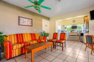 a living room with a couch and a table and chairs at Econo Lodge in Crystal River