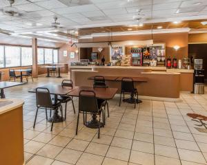 a restaurant with tables and chairs in a cafeteria at Econo Lodge in Douglas