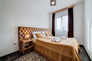 a bedroom with a large bed and a window at Zlatibor Hills 31 in Zlatibor +36 photos