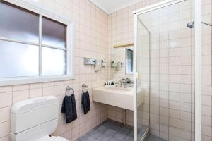 a bathroom with a toilet and a sink at Greensborough Motel in Melbourne +33 photos