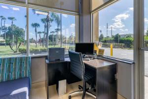 an office with a desk with a computer and a window at Quality Inn Bradenton North I-75 in Bradenton