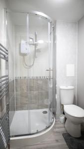 a bathroom with a shower and a toilet at City Lodge Serviced Apartments Worcester City Centre - Parking in Worcester