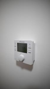 a white object with a clock on a wall at City Lodge Serviced Apartments Worcester City Centre - Parking in Worcester
