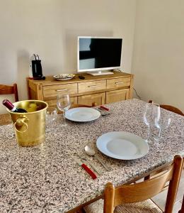 stół z dwoma talerzami i kieliszkami do wina w obiekcie Borgo Bellavista Isola Rossa w mieście Isola Rossa