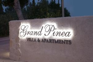 a sign for grand pines villas and apartments at Apartments Grand Pinea in Čilipi