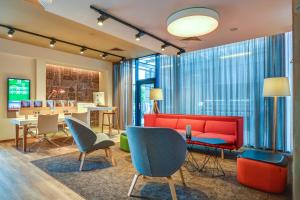 a living room filled with furniture and a large window at Holiday Inn Prague Airport, an IHG Hotel in Prague