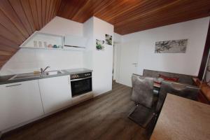 a kitchen with a sink and a table and chairs at Haus Trude in Olsberg